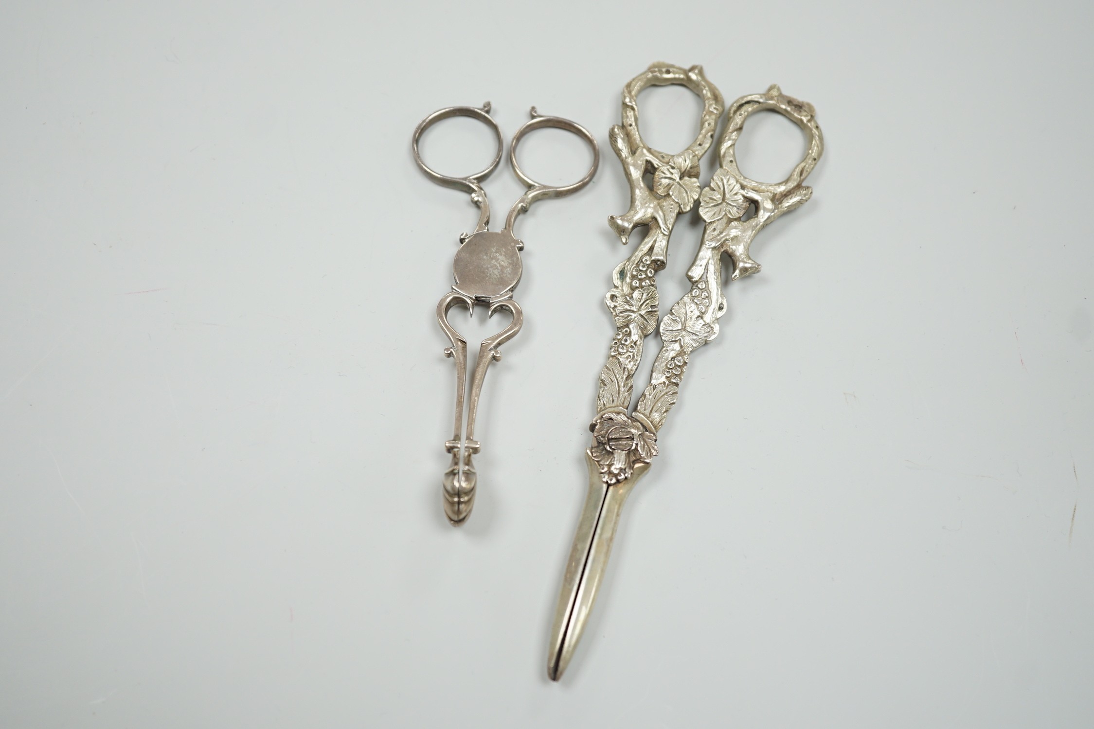 A pair of Victorian silver grape scissors, TS?, London, 1879, 17cm and a pair of Georgian silver sugar nips by Simeone Coley?